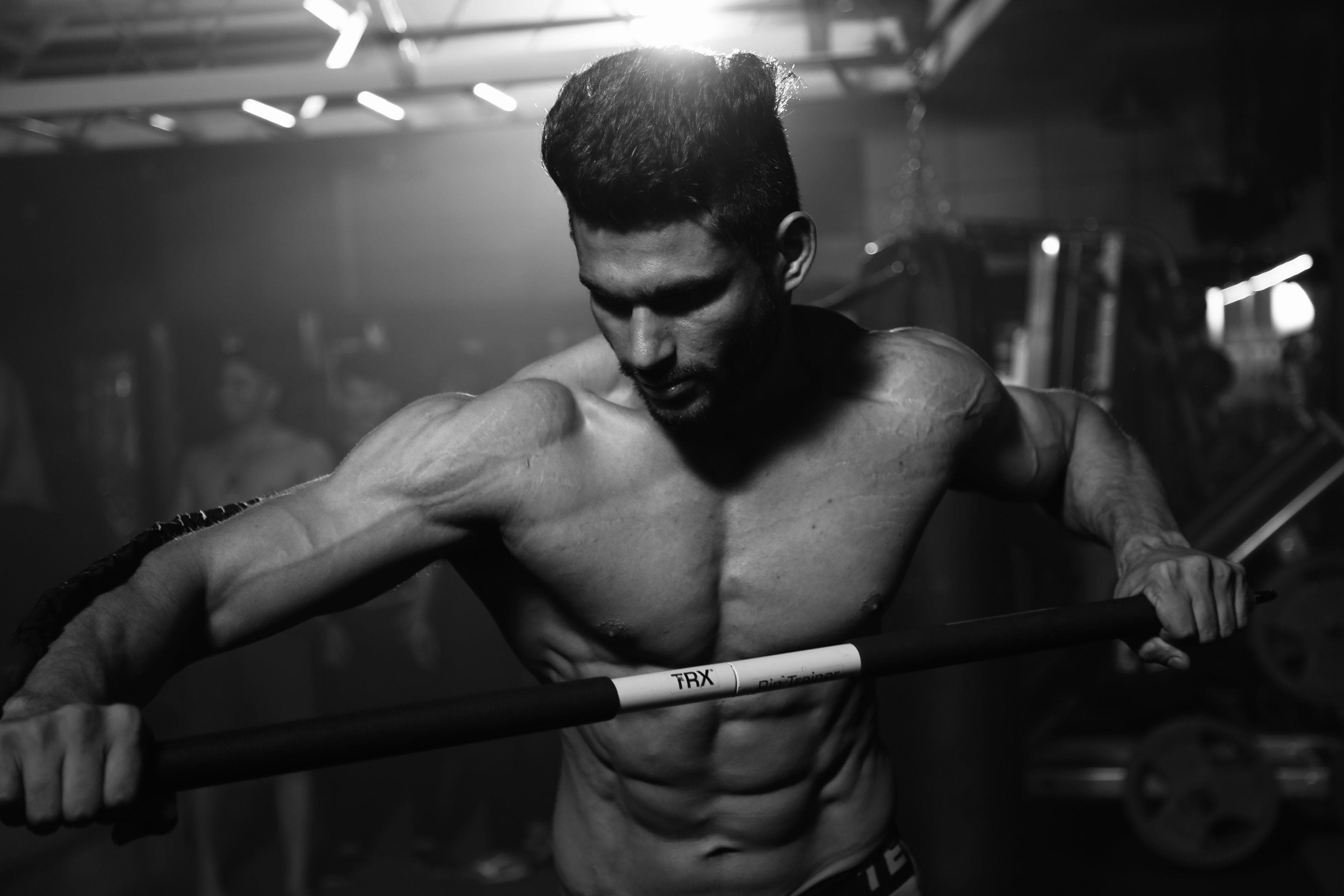 Coach performing functional suspension training
